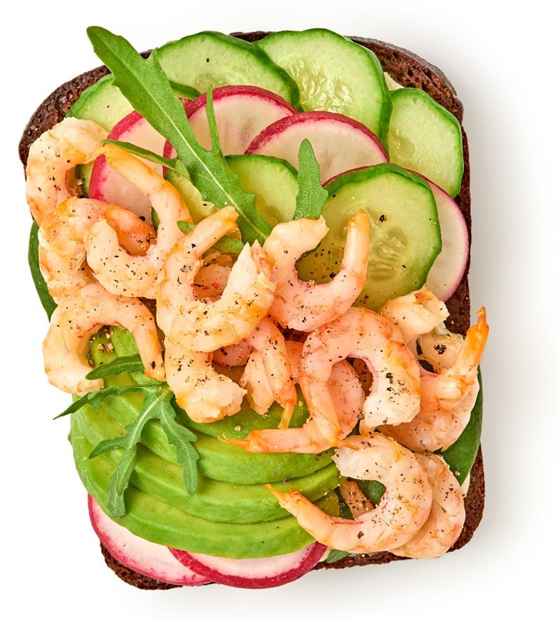 Shrimp and cucumbers on a slice of wheat bread